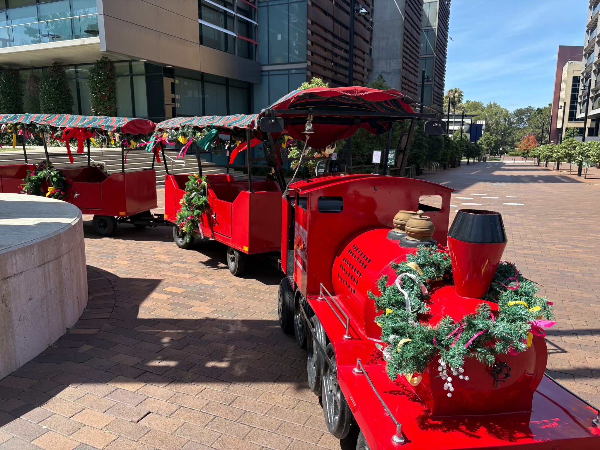 Decorated red trackless train for Christmas event hire